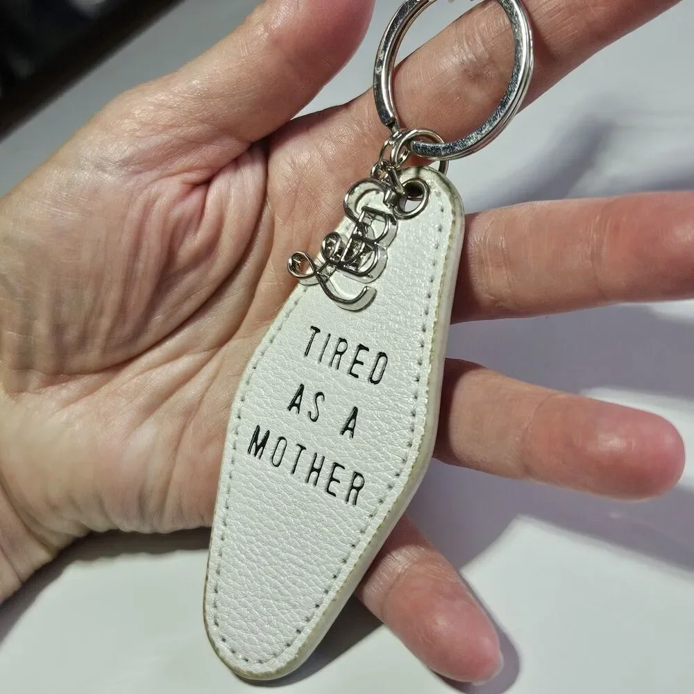 Santa Barbara Design Studio Silver Tone White Leather Tired As A Mother Keychain